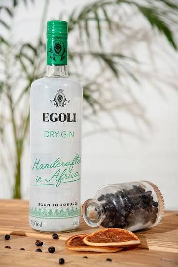 Egoli Dry Gin bottle with botanicals and dried citrus